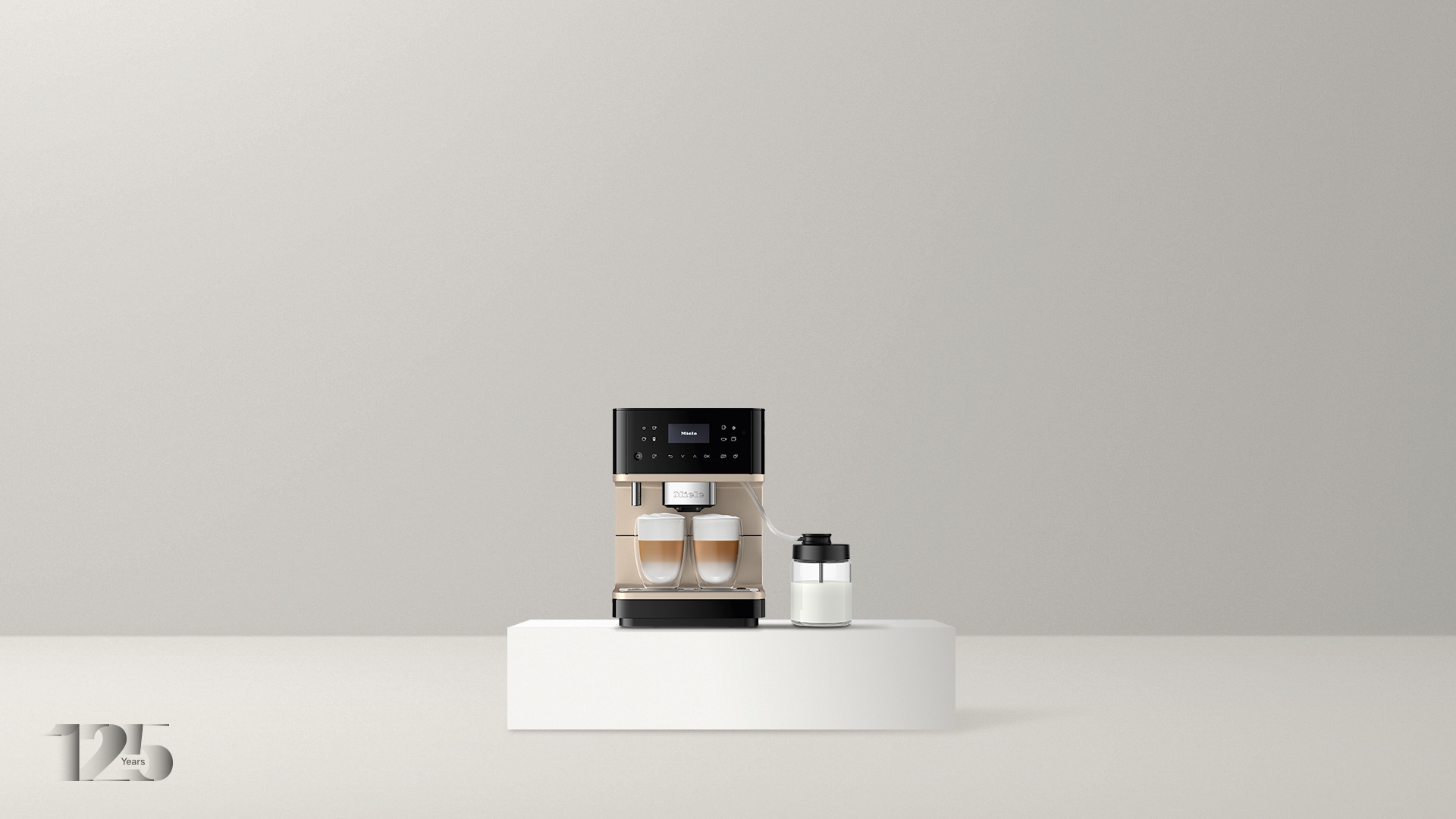 Front view of the CM 6360 MilkPerfection; the coffee machine is black with rose gold metallic accents and has two freshly brewed lattes under the spout
