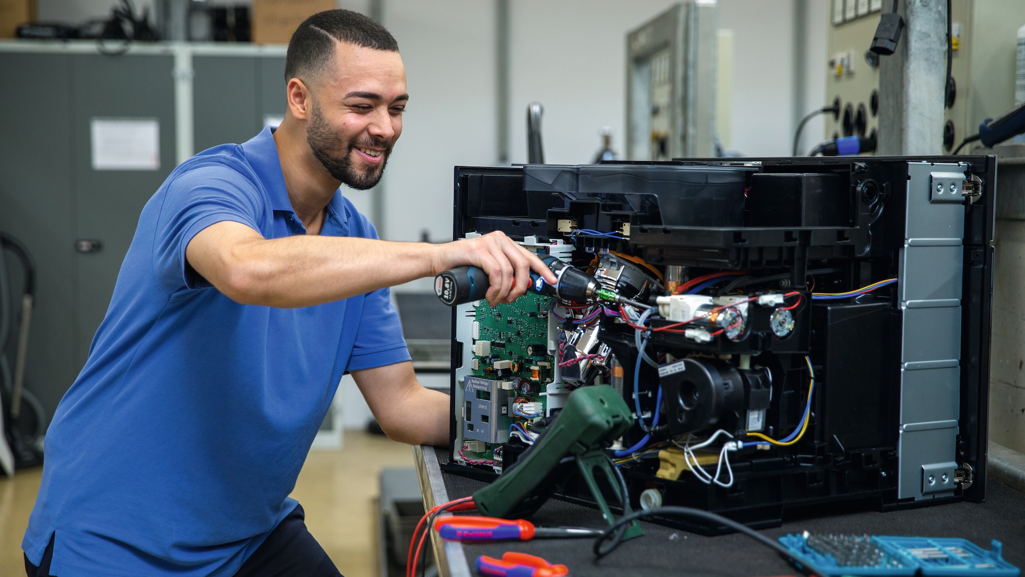 a Miele representative cleaning a Miele dishwasher