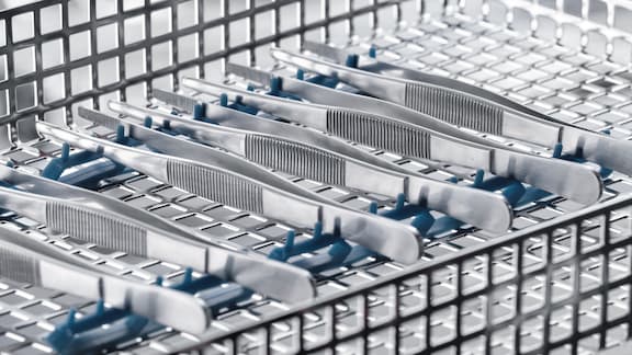 Medical pinzettes inside Miele Professional mesh tray