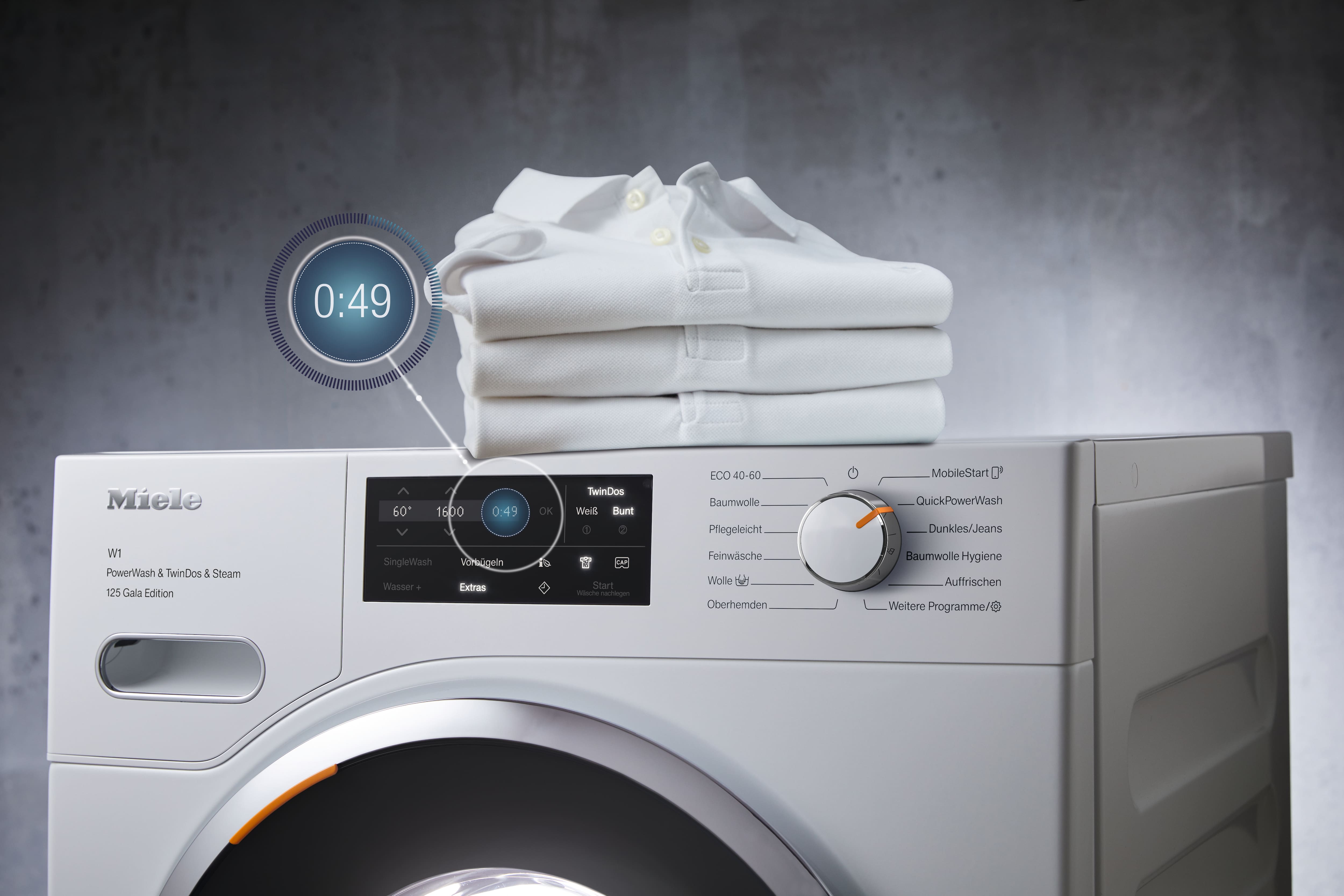 Miele washing machine with a graphic display on its left displaying 49 minutes timer