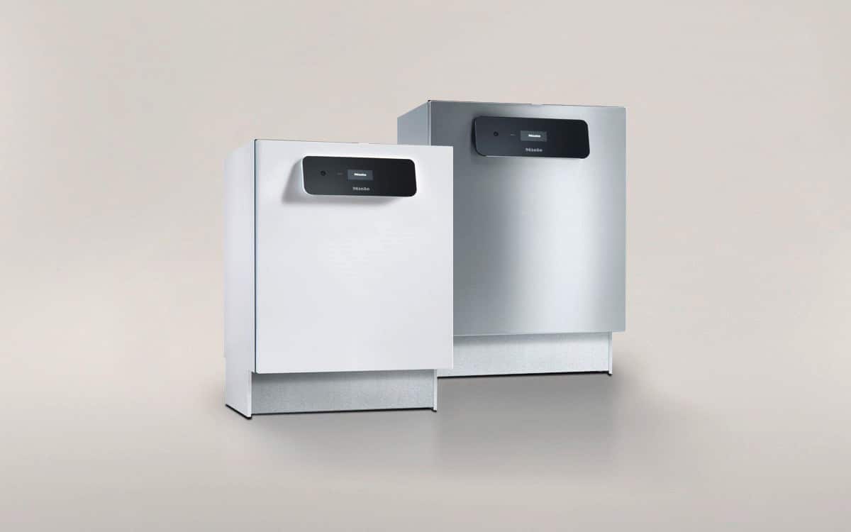 Two dishwashers next to each other against a grey background