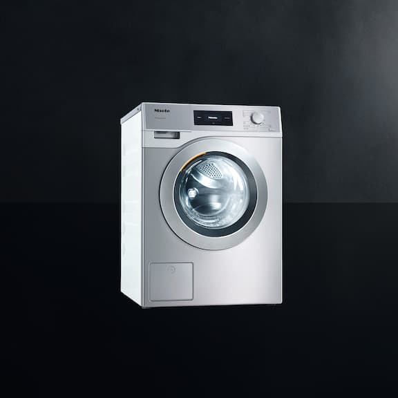 The Miele Little Giant washing machine PWM 507 is displayed on a black background.