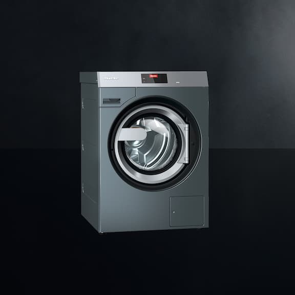 The Miele Benchmark Performance washing machine PWM 511 is displayed on a black background.