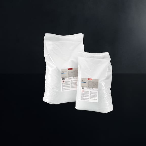 Two packages of ProCare Tex 11 detergent are displayed on a black backgrond