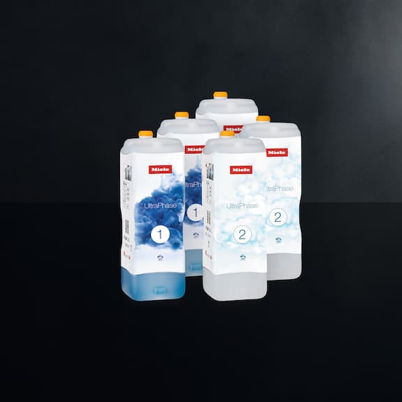 The Miele 5-package-set of UltraPhase 1 and 2 detergents is displayed on a black background.
