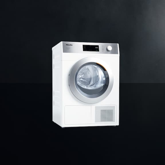 The Miele SmartBiz heat pump dryer PDR 1108 HP is displayed on a black background.