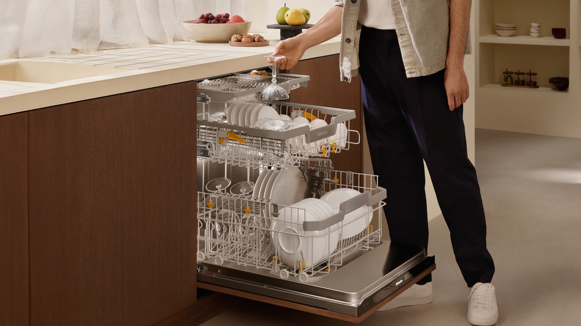 laundry room with hanged shirts and Miele washing machine