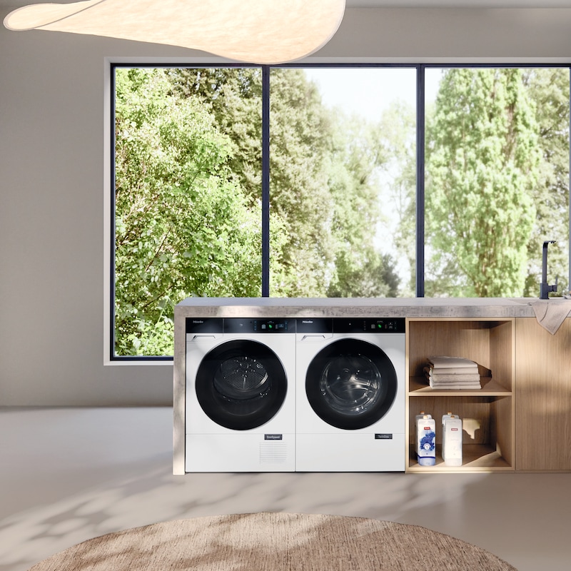 Image of a woman using a Miele washing machine