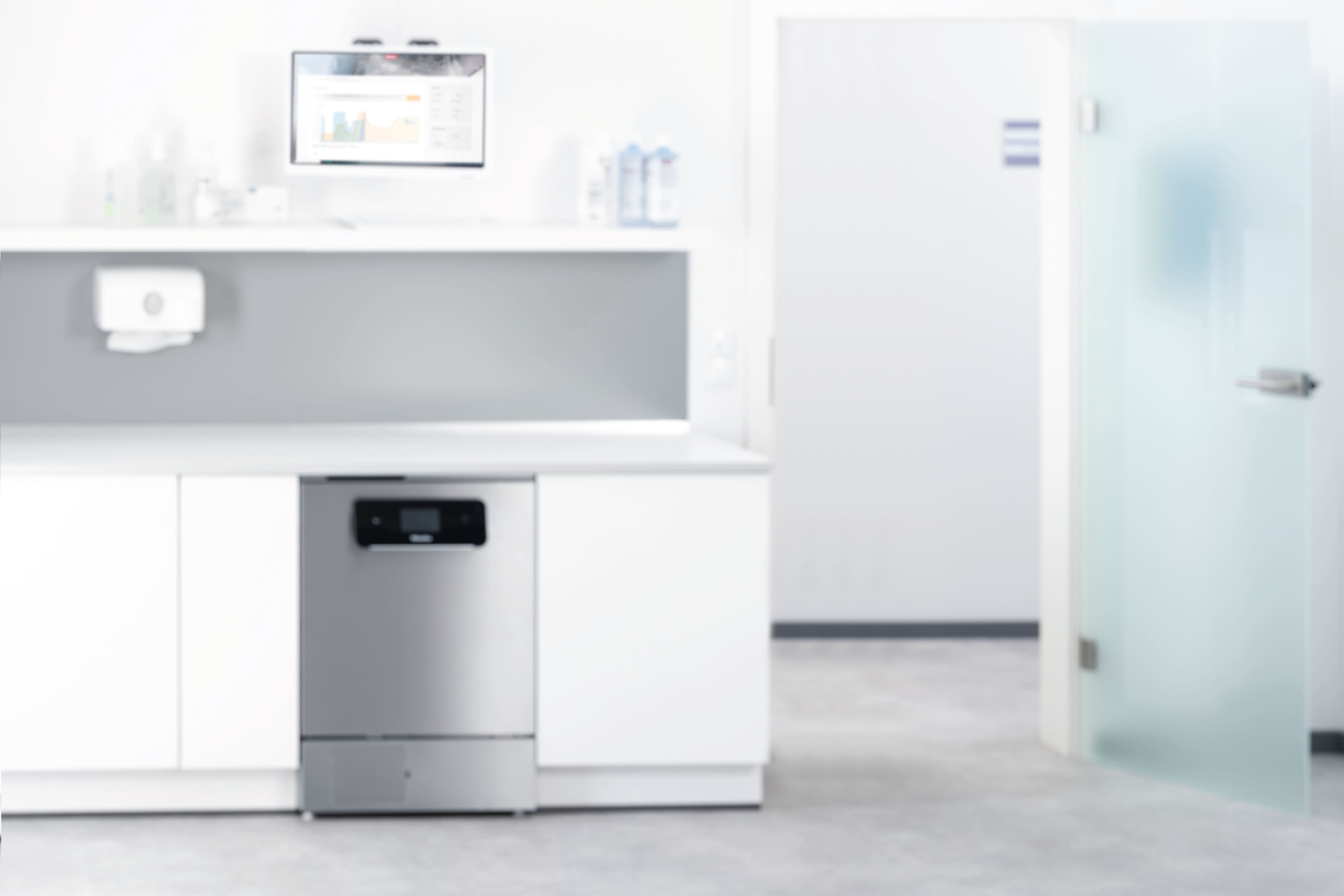 A dental assistant loads the ExpertLine unit with instruments