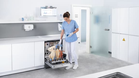 A medical assistant loads ExpertLine washer disinfector with anaesthesia equipment