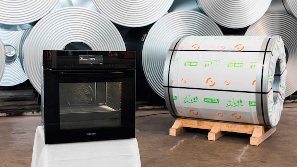 a Miele oven next to a big roll of the material used to make part of it