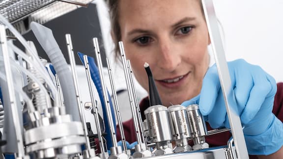 A close-up of a dentist checking devices in a steriliser