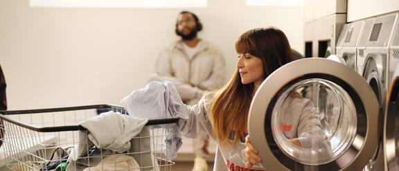 The Miele Professional Little Giants washing machine with the retrofittable coin-operated payment system is located in a launderette.