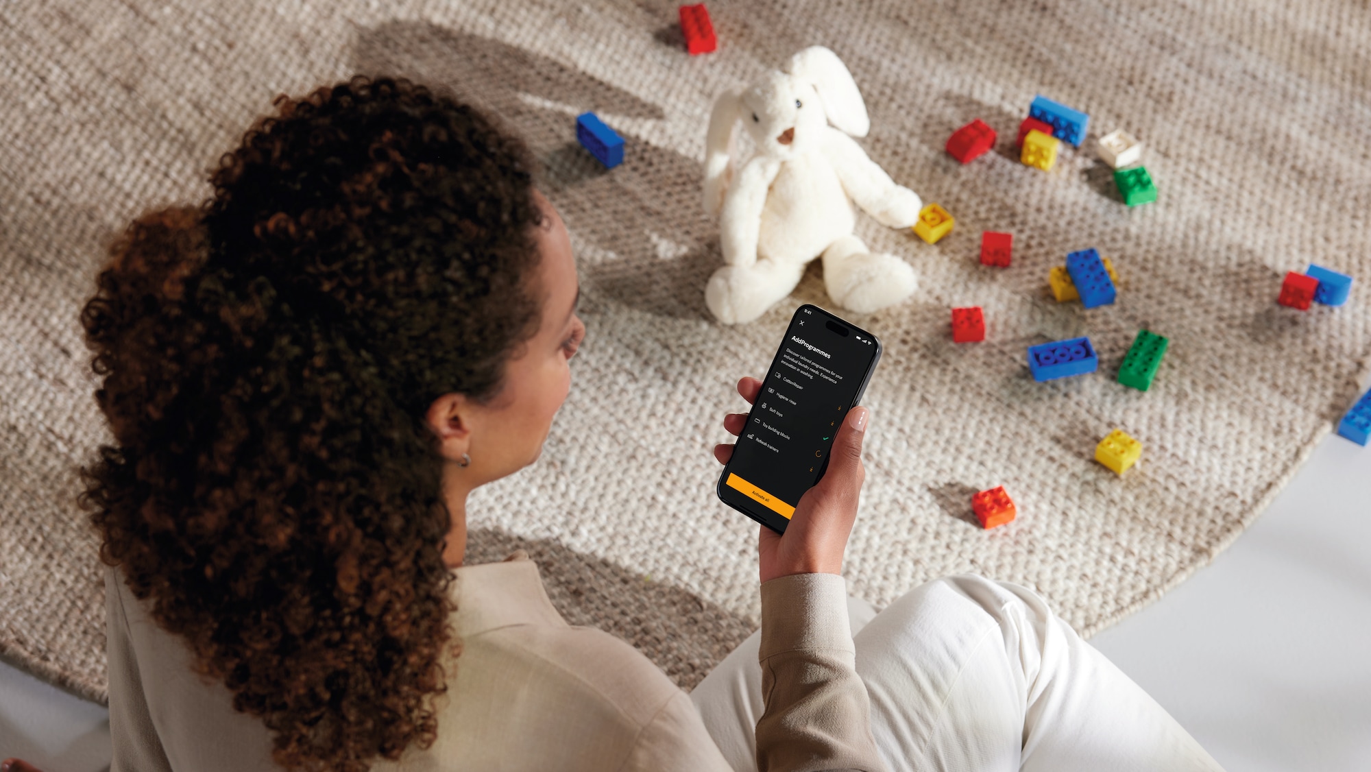 Woman using the Miele App on her phone