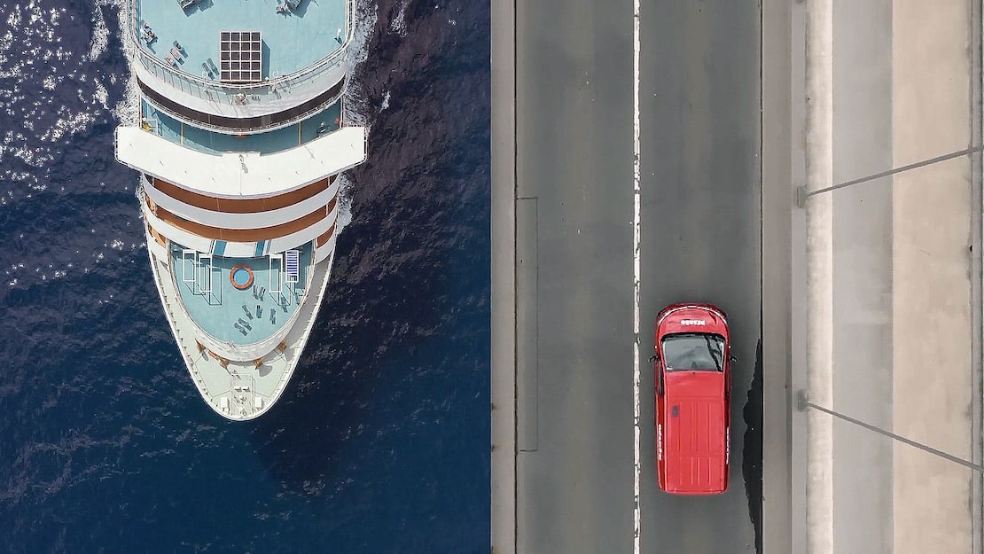 Bird’s eye view of a ship and red service van