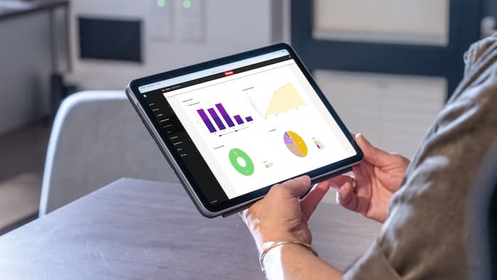 Tablet displays statistics of machine data within Miele MOVE Connect.