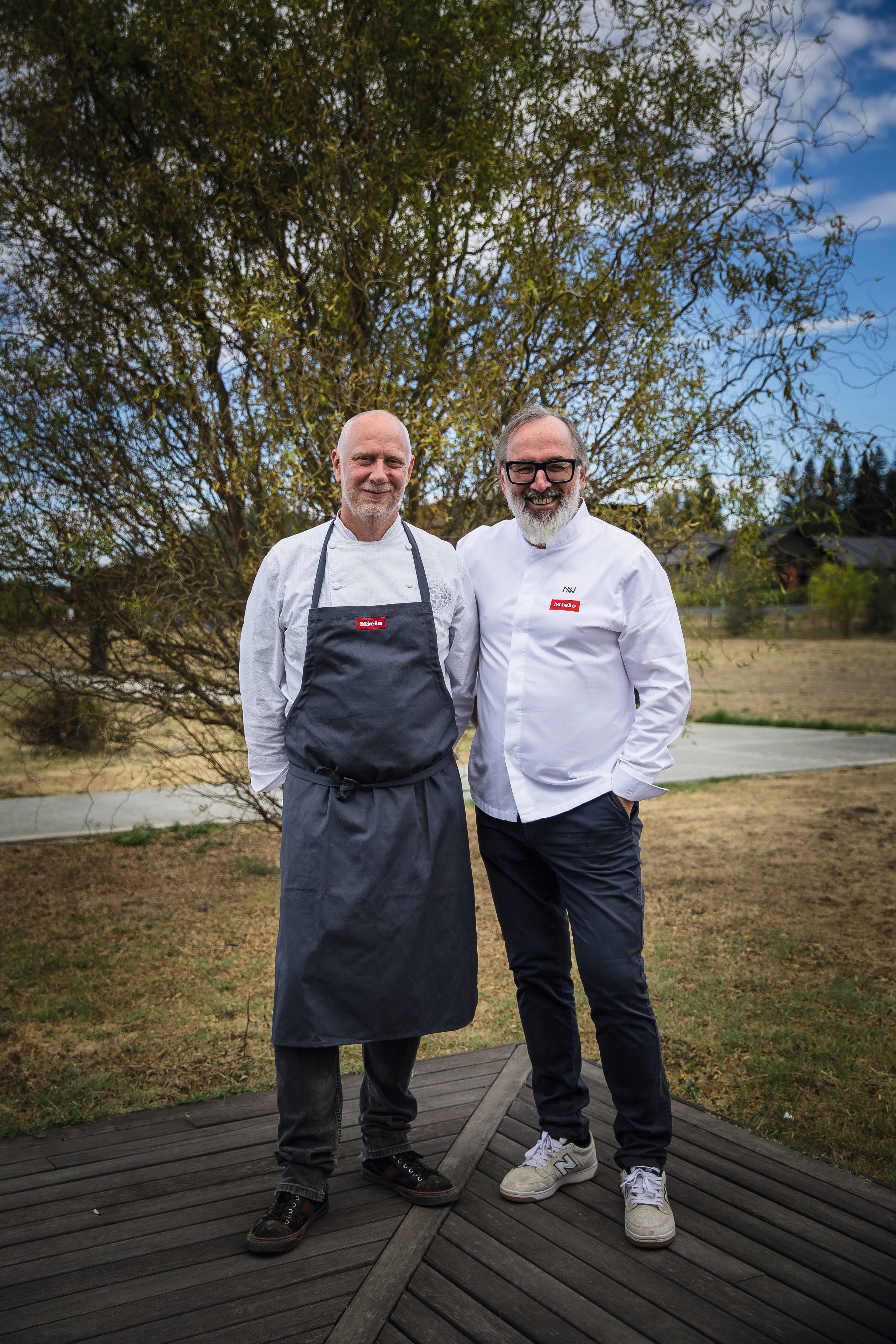 Chef Kyle Connaughton and Chef Norbert Niederkofler in a field 