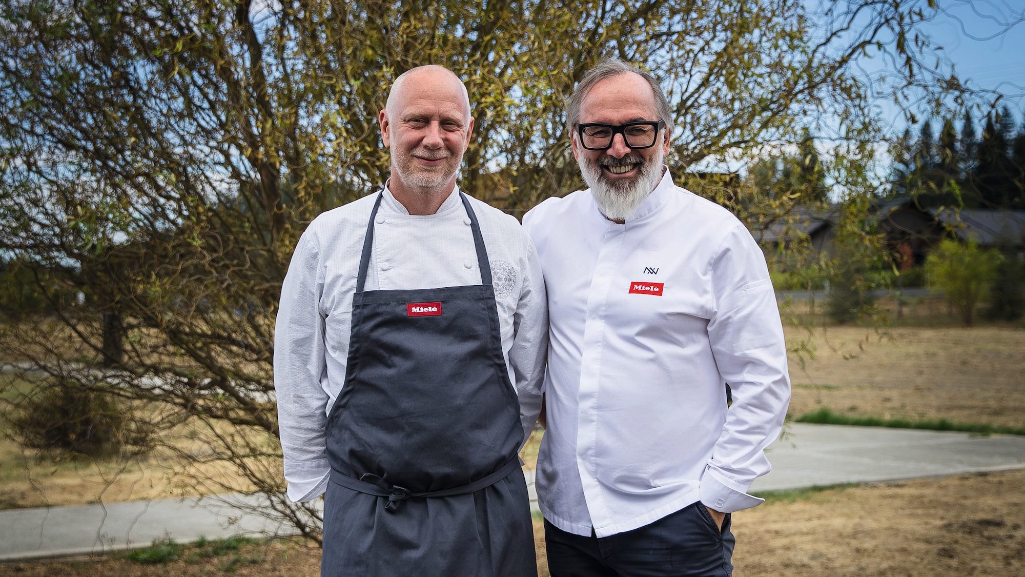 Chef Kyle Connaughton and Chef Norbert Niederkofler in a field