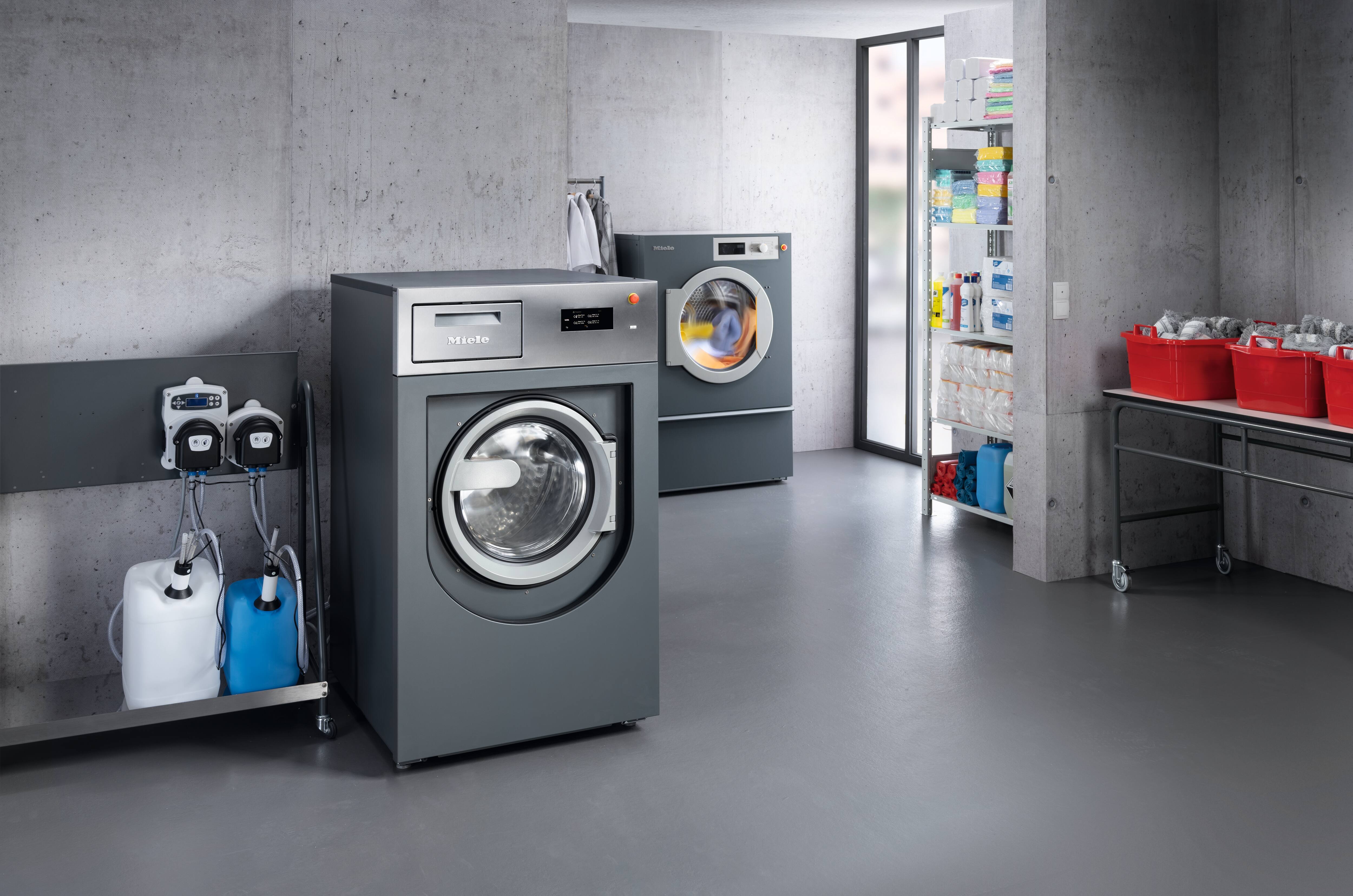 A PWM 514 Benchmark Performance washing machine is connected to an automatic dispensing system.