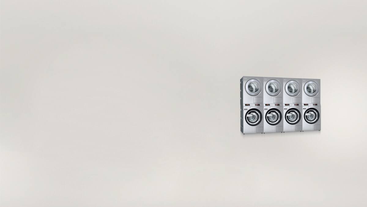 Washer-dryer stacks against a grey background