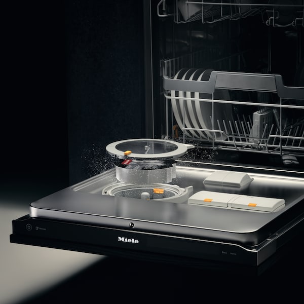 Opened dishwasher with the PowerDisk coming out in CGI to showcase where it sits in the machine