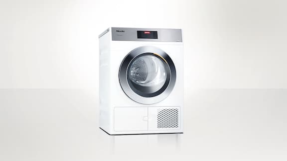 Suszarka z pompą ciepła Miele Professional z serii Małe Olbrzymy PDR 908 HPP na neutralnym tle.