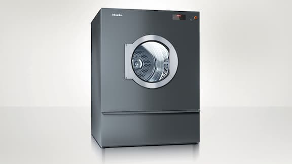 Miele Professional Benchmark PDR 944 tumble dryer against a neutral background. 