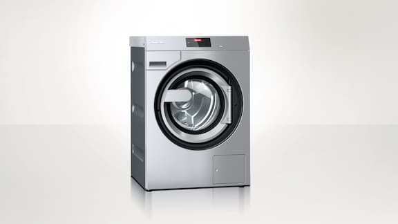 Miele Professional Benchmark PWM 909 washing machine against a neutral background. 