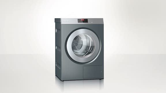 Miele Professional Benchmark PDR 910 tumble dryer against a neutral background.