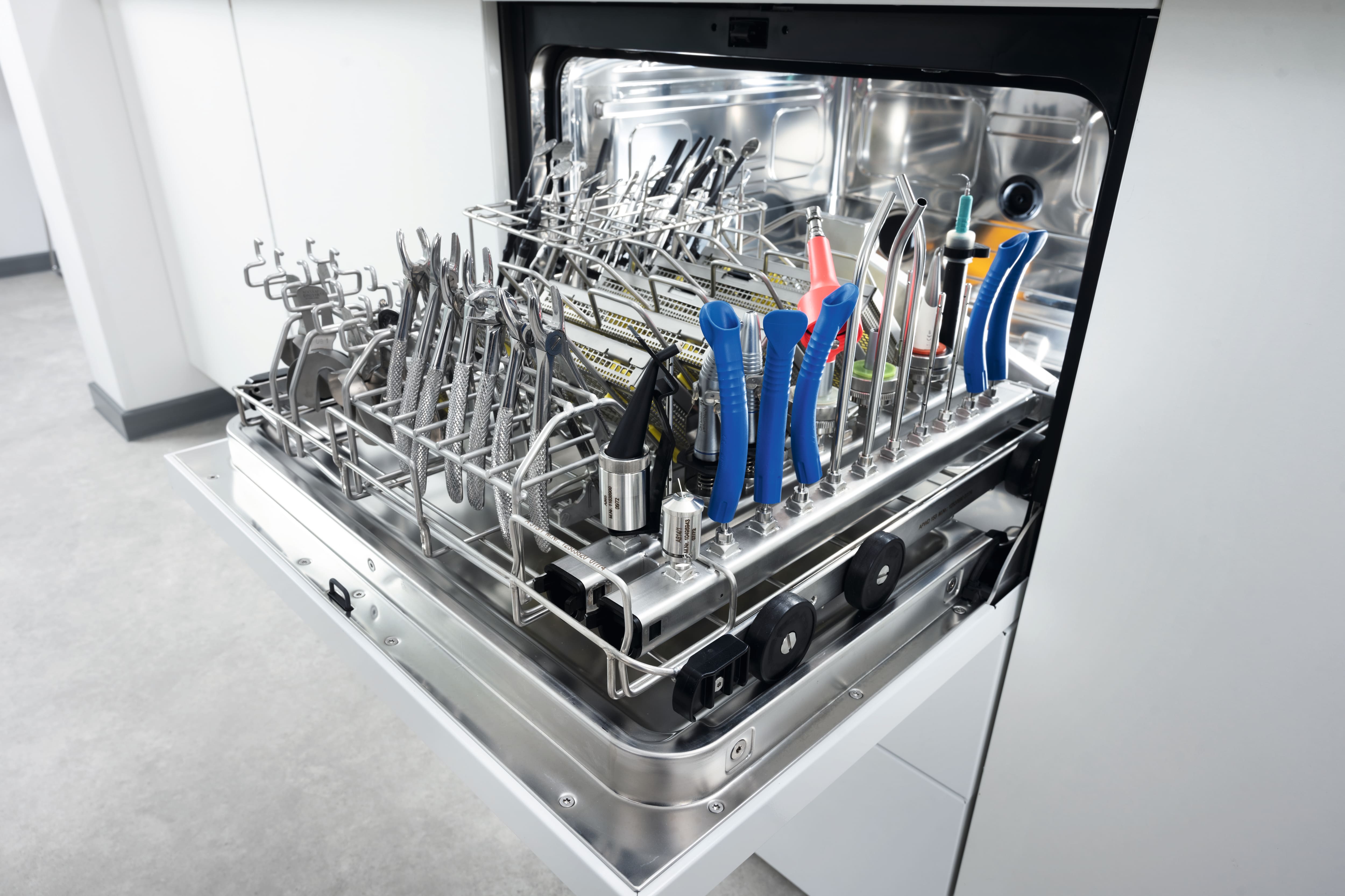 A CompactLine Thermal washer disinfector loaded with clean dental instruments after a cycle