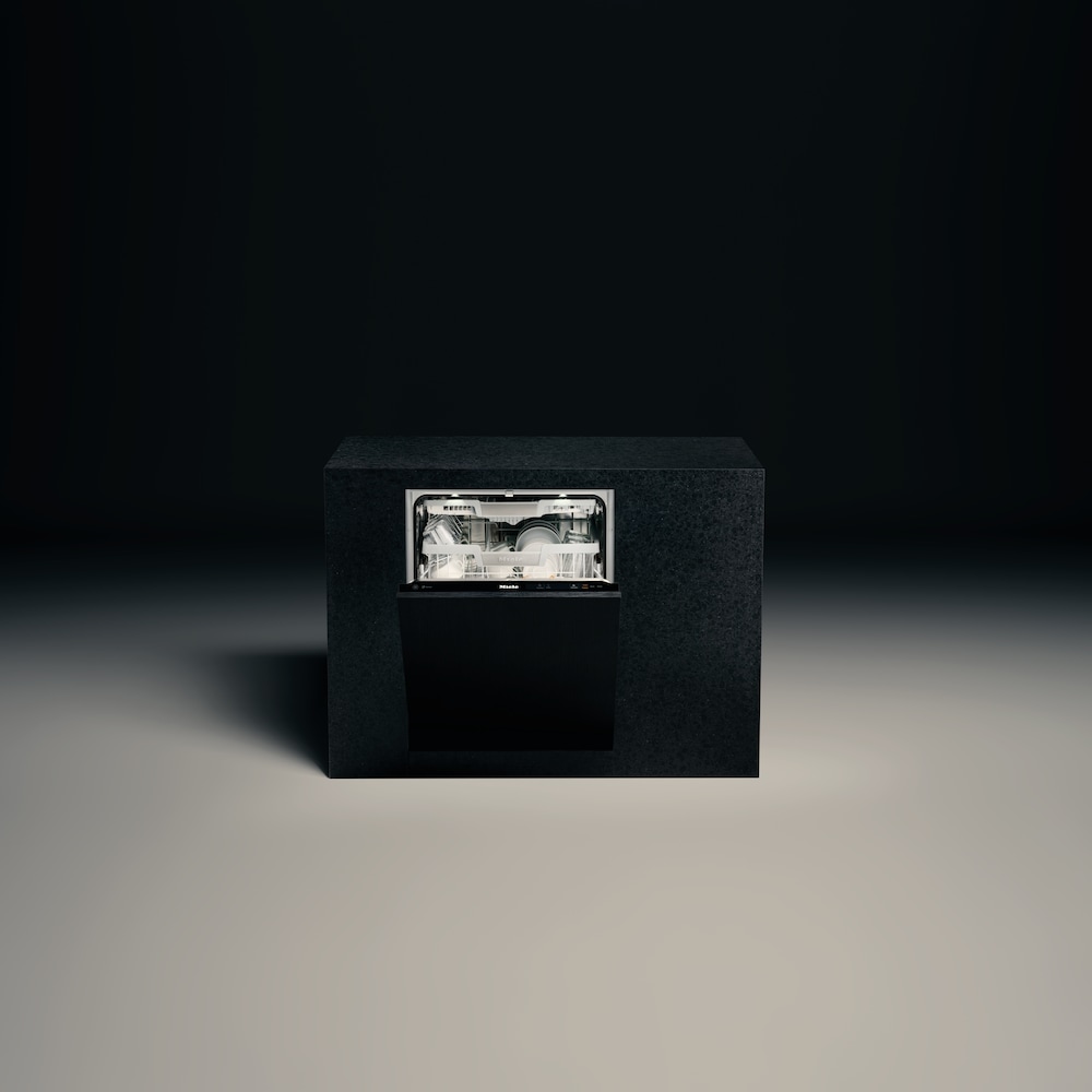 Miele Dishwasher with its door opened, standing alone in a dark background setting