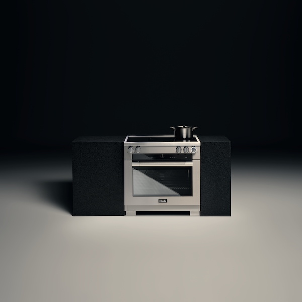Miele Induction Range against a generic gray background.