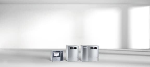 Miele Professional range ofWasher disinfectors for the medical sector, including a small benchtop option, an undercounter unit, and an undercounter unit with a cabinet for automated chemical dispensing.
