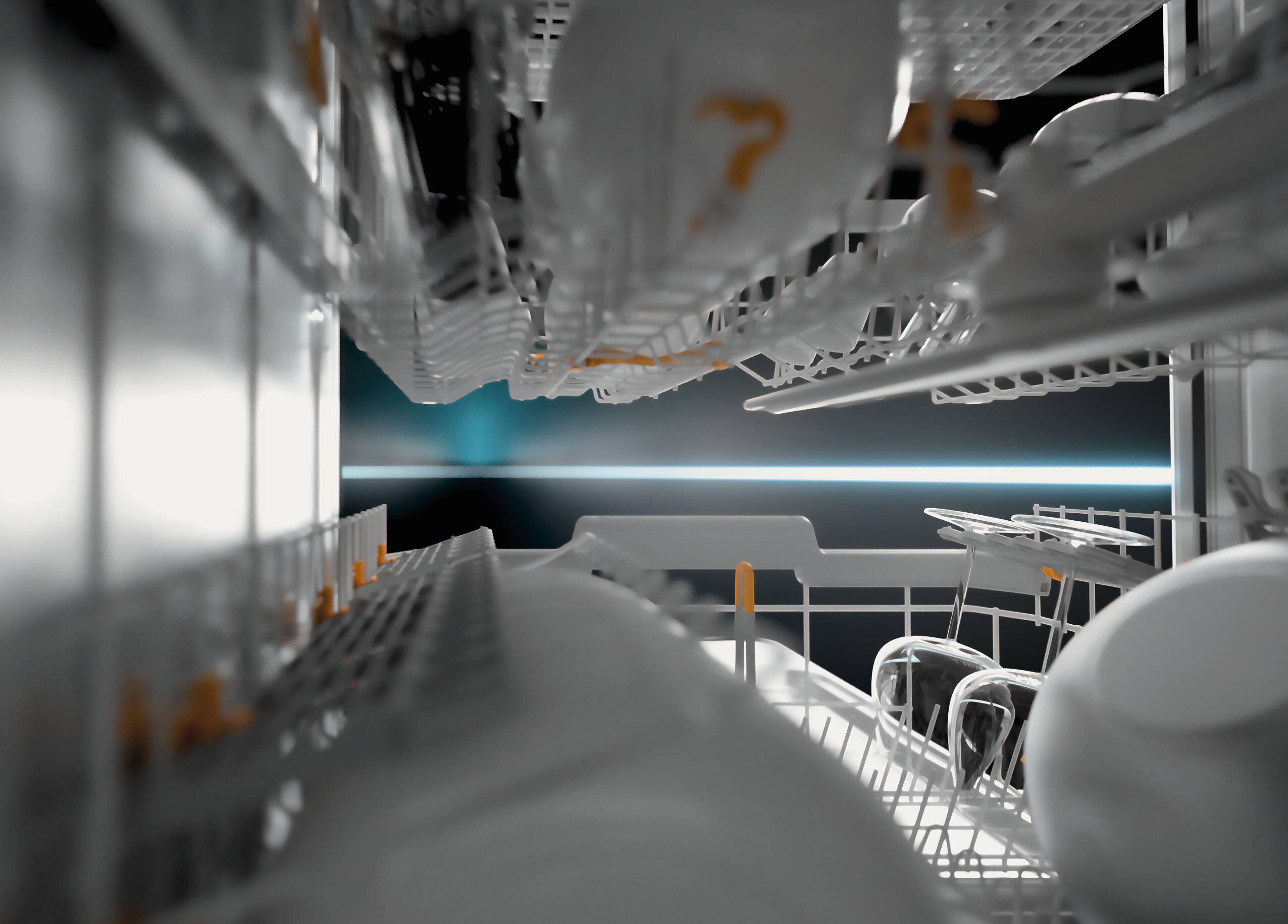 View inside a dishwasher with white crockery, a blue LED light in the background.