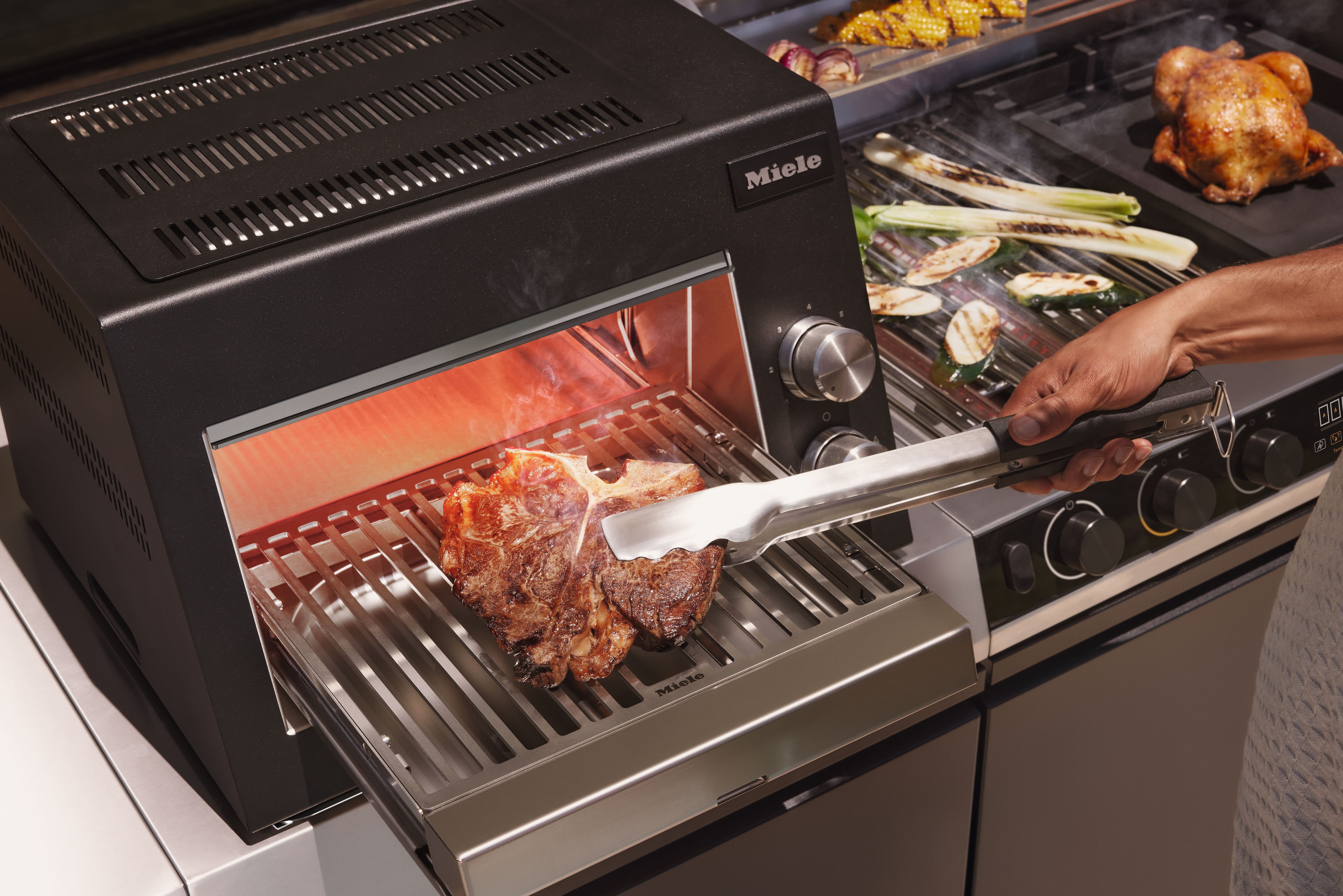 cooking meat in the outdoor kitchen cooking meat in the outdoor kitchen