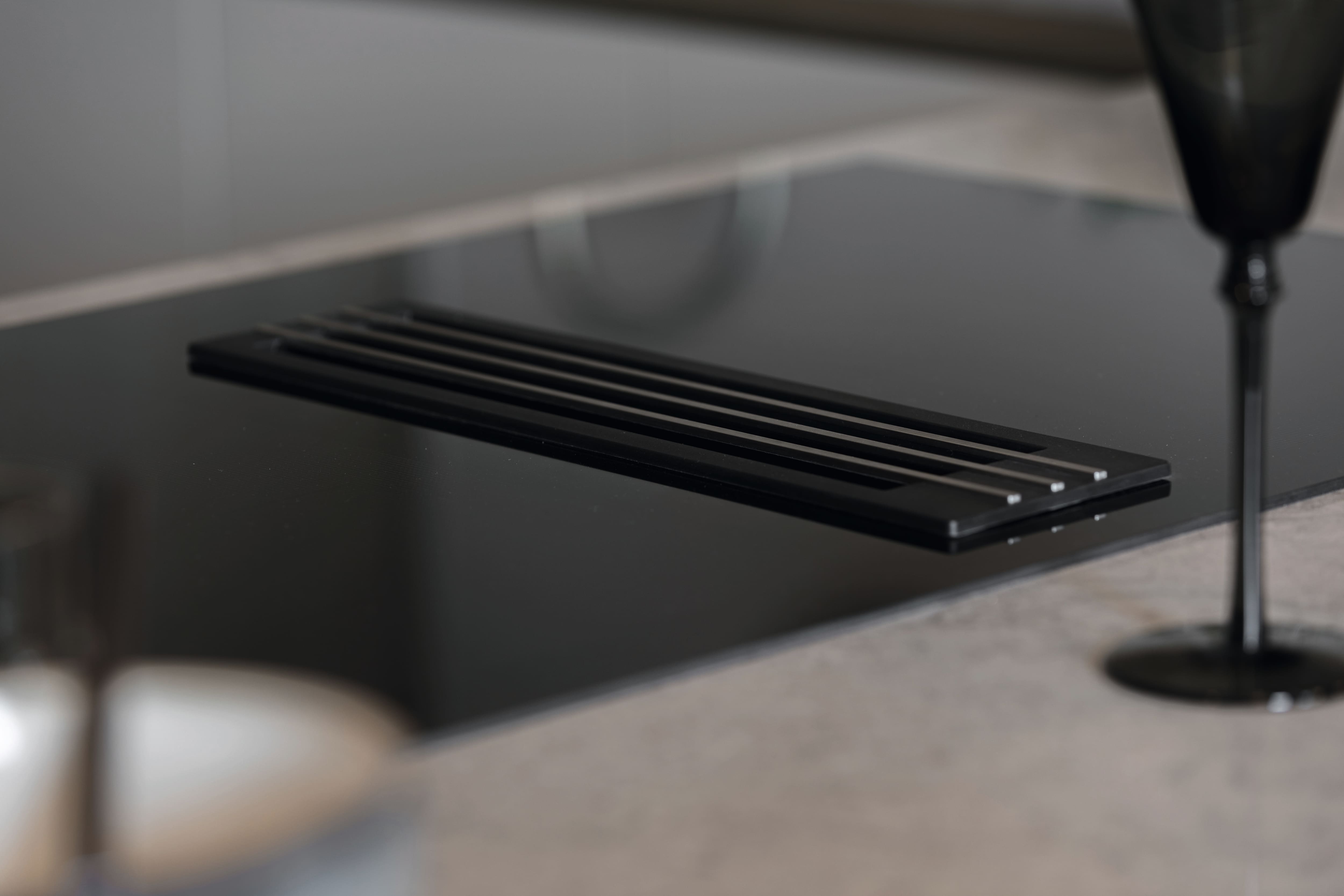 Close-up detail of a Miele hob with integrated extractor