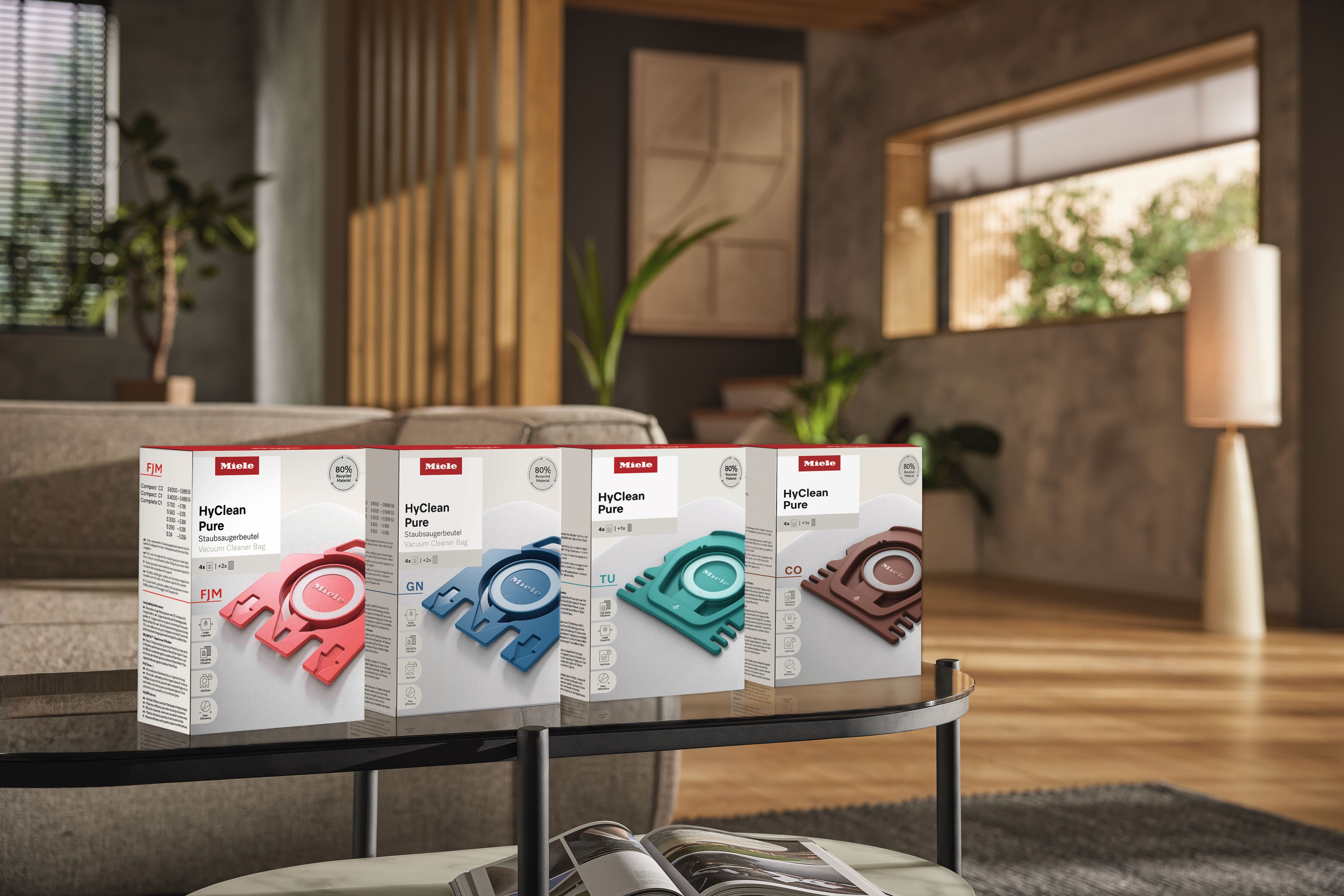 vacuum cleaner bag on table, Miele vacuum in background